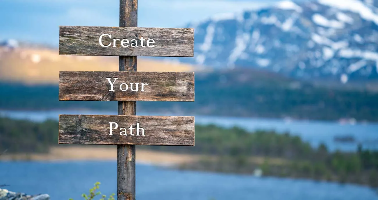 Wooden signs pointing towards a mountain landscape